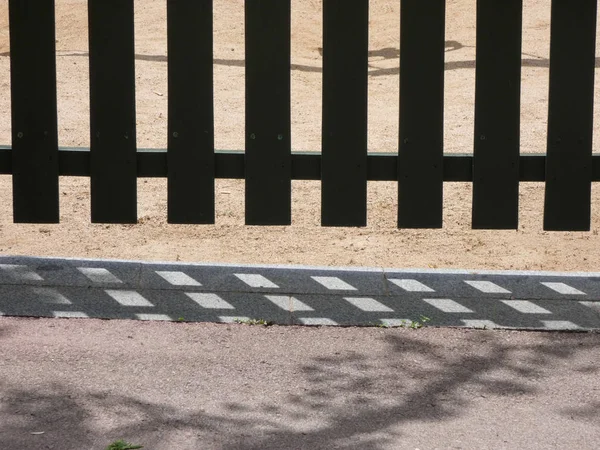 wooden fence that protects the playground, so that children do not leave and to prevent unauthorized people or animals from entering