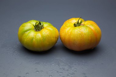 Domatesler yeşilden kırmızıya, olgunlaşma işlemi. Yeşil domates henüz tüketime hazır değil, kırmızı domates vitamin ve lezzet dolu, tüketim için hazırlanan.