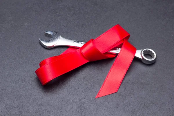 professional tool wrapped with a red bow