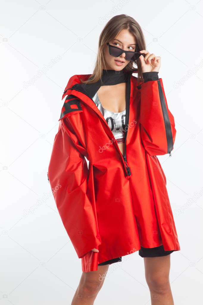 Beautiful girl, model with futuristic urban clothes, expressions of a beautiful girl on white background