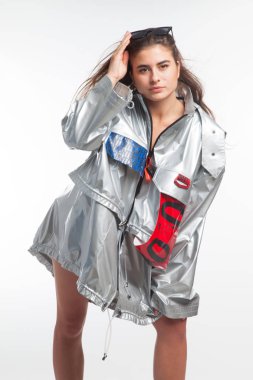 Güzel, seksi, şehvetli kız beyaz arka plan üzerinde fütüristik kentsel giysiler ile poz