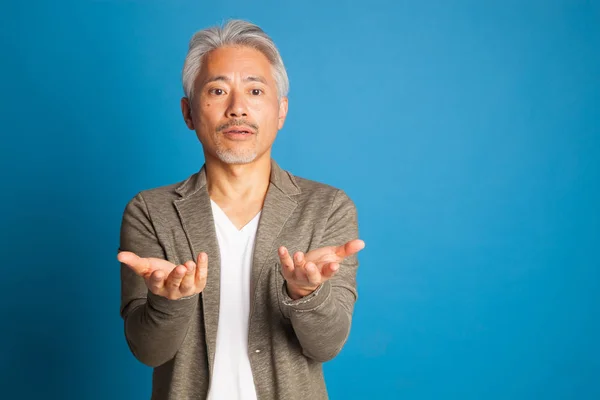 Middle-aged man of Japanese origin, gesturing with his arms and hands; expressive man.