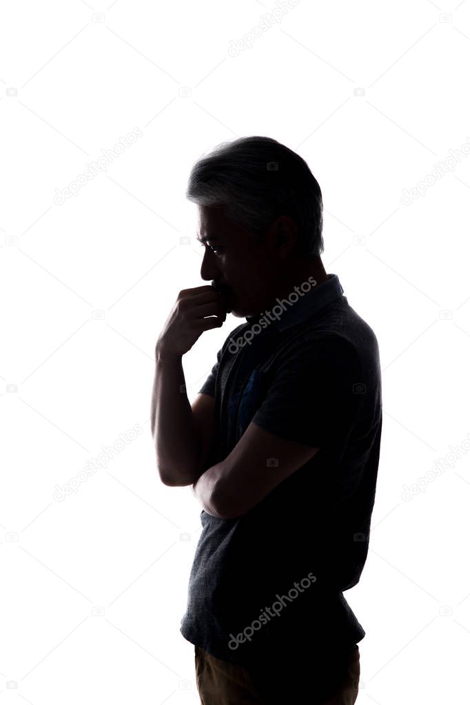 Man making martial arts gestures, training Karate positions; shadows and silhouette of a man doing sports