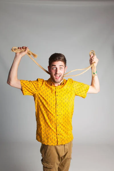 young boy with the rope around his neck, desperate, playing to take his life to hang himself, suicide