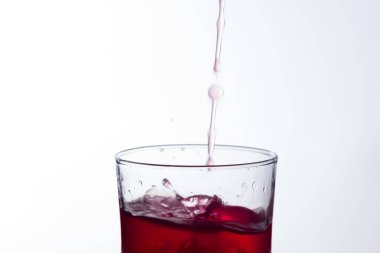 Temiz, içme suyu temiz bir bardağa dökülüyor, sağlıklı, sağlıklı, temiz, kokusuz ve tatsız bir su. Yüzeye su damlaları sıçrıyor. Jet su bardağa giriyor