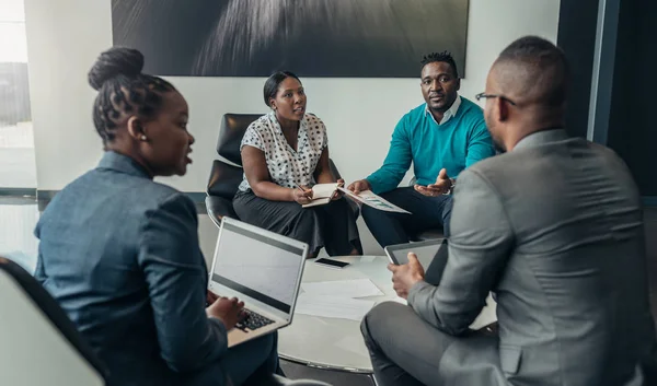 Team of african business people debating during a work meeting.