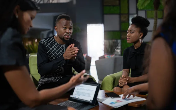 Black african business analyst in strategy meeting. Using hand gestures with serious and concerned tone