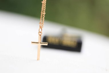 Gold Christ cross lace with holy bible, black cover. European religion conceptual for Christian faith, pray and hope clipart