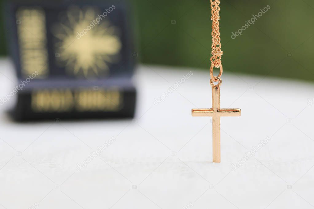 Gold Christ cross lace with holy bible, black cover. European religion conceptual for Christian faith, pray and hope
