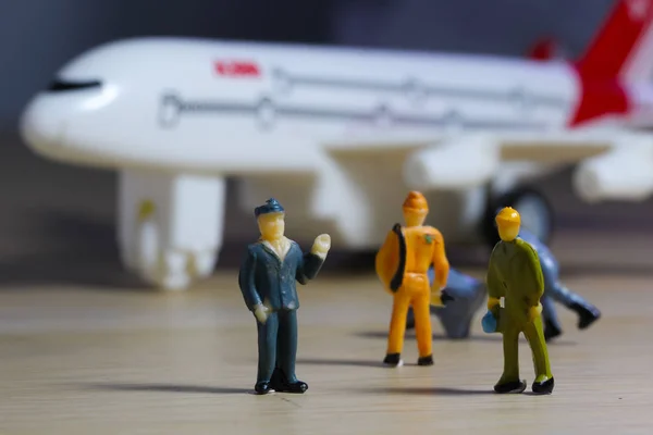 Airplane engineer, airport worker, aircraft people working in preparing, fixing, repairing the runway and checking the airplane. Many level of miniature company employee and employer figures as flight concept