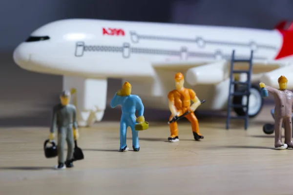 Airplane engineer, airport worker, aircraft people working in preparing, fixing, repairing the runway and checking the airplane. Many level of miniature company employee and employer figures as flight concept