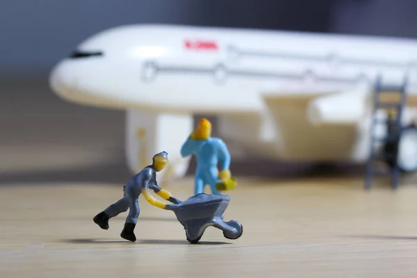Airplane engineer, airport worker, aircraft people working in preparing, fixing, repairing the runway and checking the airplane. Many level of miniature company employee and employer figures as flight concept