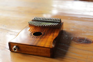 Kalimba or mbira is an African musical instrument. Traditional to the Shona people of Zimbabwe. Kalimba made from wooden board with metal, play on hands and plucking the tines with the thumbs clipart
