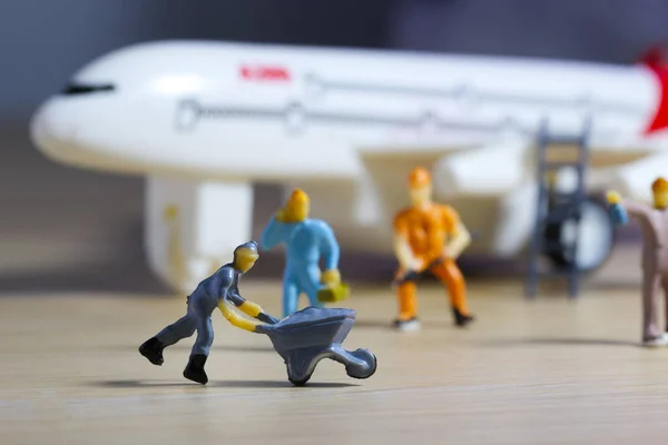 Airplane engineer, airport worker, aircraft people working in fixing, repairing the runway and checking the airplane. Many level of miniature company employee and employer figure as flight concept