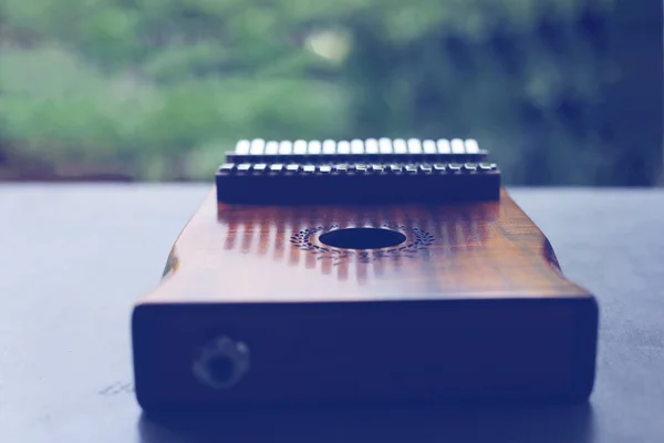 Kalimba or mbira is an African musical instrument.Traditional to the Shona people of Zimbabwe. Kalimba made from  wooden board with metal, play on hands and plucking the tines with the thumbs