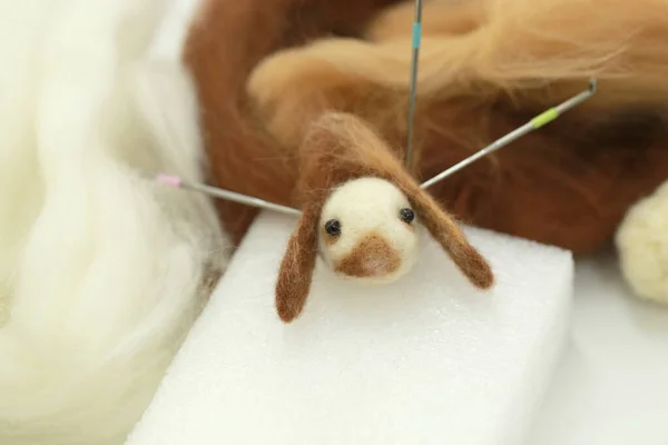 Needle felt, wool weaving handmade craft by sheep hair. Sheep hair wool made by needle press to be doll.