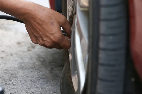 Flat black tire of automobile car in changing for fix the hole or unflat tire car on road