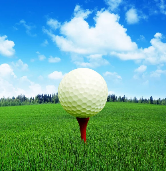 Golf ball on tee in a beautiful natural landscape.