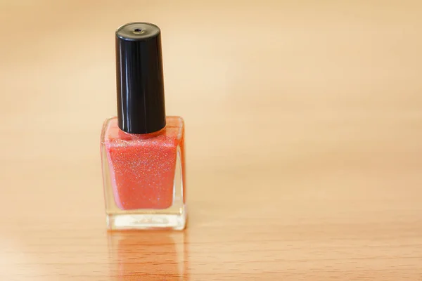 Nail polish bottles on a wooden table.