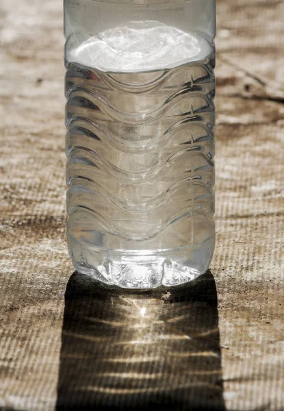 The sun shines through a water bottle that causes light and harmful combinations.