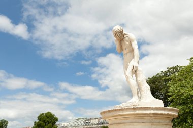 PARIS, FRANCE - 02 June 2018: A facepalm statue. In The Garden Of Tuileries, near Louvre. Cain after the murder of his brother Abel. Sculpture by Henri Vidal ,1896 .Jardins des Tuileries.