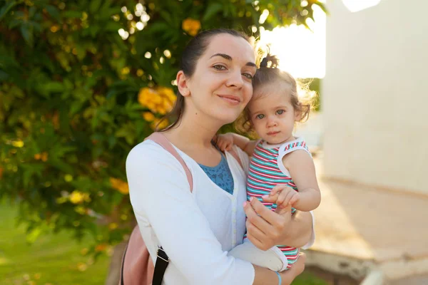 Mother hugging with her little daughter outdoor in nature on sunny day Positive human emotions, feelings, emotions. — Stock Photo, Image