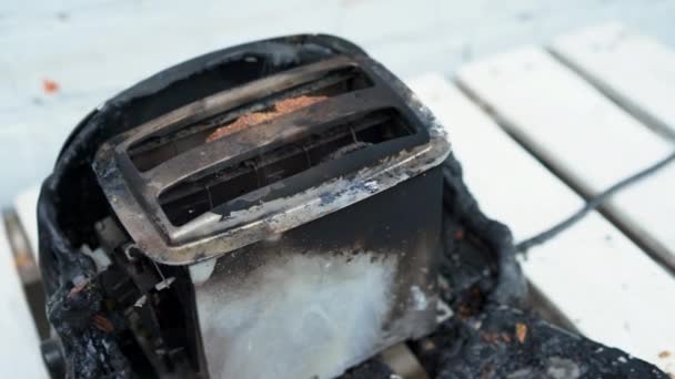 Burning toaster. Toaster with two slices of toast caught on fire over white background — Stock Video