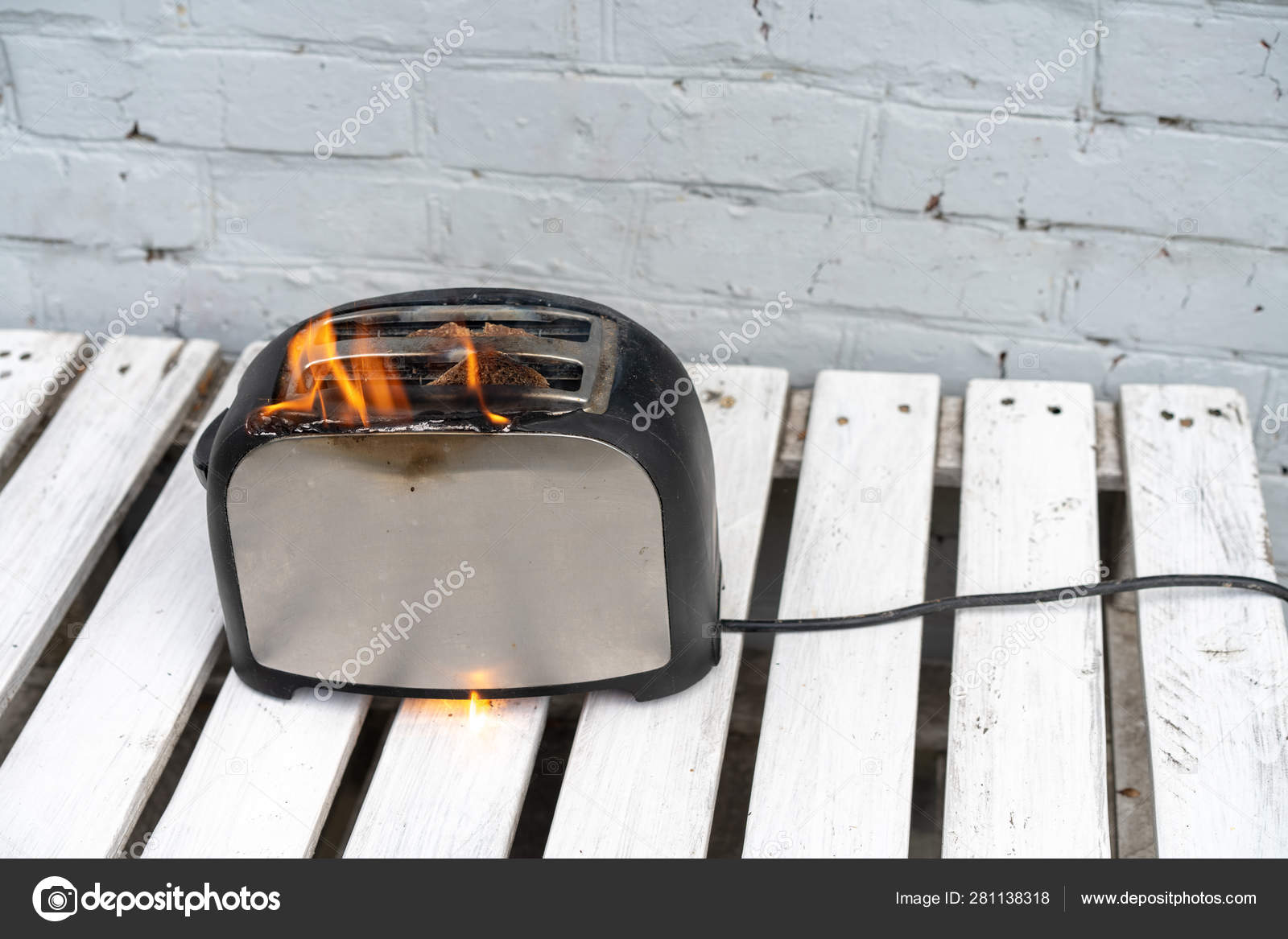 Burning Toaster with two slices of toast caught on fire