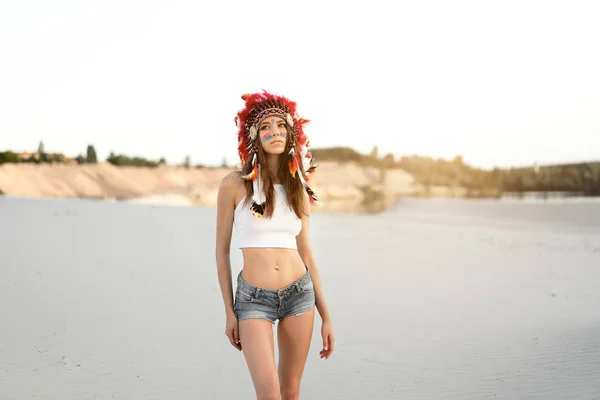 A beautiful young Caucasian girl in a white top and denim shorts — Stock Photo, Image