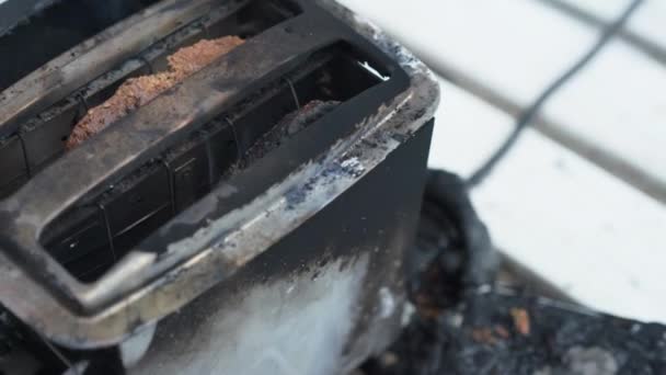 Burning toaster. Toaster with two slices of toast caught on fire over white background — Stock Video