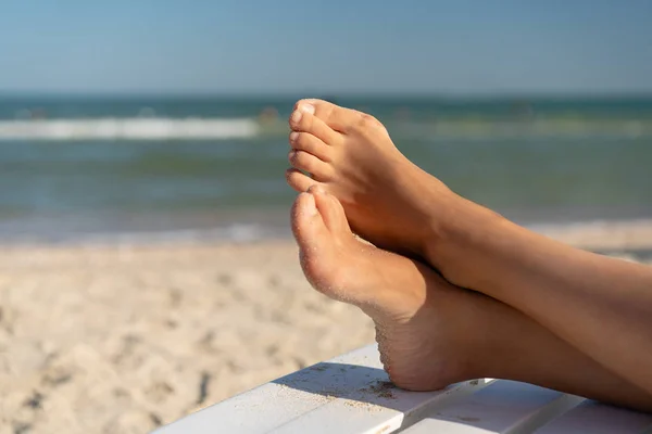 Female foot with hallux valgus close up on the beach — Stock Photo, Image