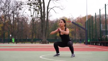 Ukrayna. Kharkov Ekim 2019 Koşucu, spor sahasında antrenman öncesi ısınmaya hazır bir kadın. Spordan önce parkta esneme hareketleri yapan zinde bir kızın gerçek zamanlı videosu.
