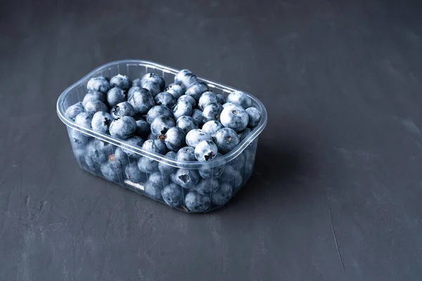 Tasty Juicy Raw Blueberries Plastic Container Black Dark Background Packaging — Stock Photo, Image