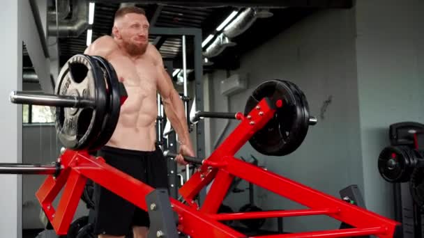 Gym man lange halter lift gewichten platen oefening machine. Knappe blanke atleet workout — Stockvideo