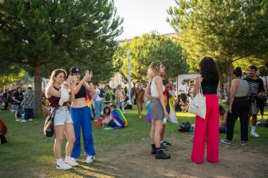 Lisbon, Portugal 17 June 2023 Participants gather in a lively park during the LGBT pride parade, expressing joy and unity. Colorful outfits, flags, and a festive atmosphere 