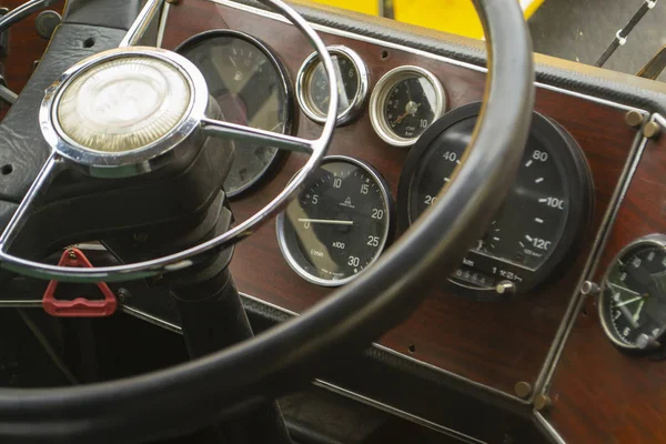 The cabin of the old bus. Vintage dashboard. Leather steering wheel