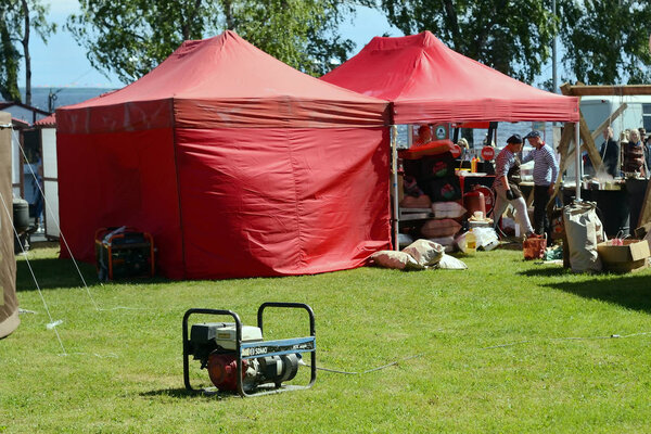 electric generator on the background of cafe tents
