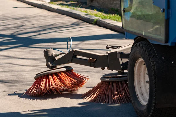 sweeper in the process of cleaning the sidewalk. street cleaning equipment