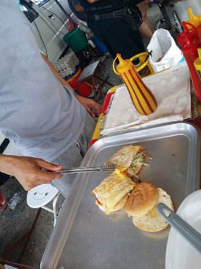 et ve yumurta burger hazırlayan tanınmayan biri