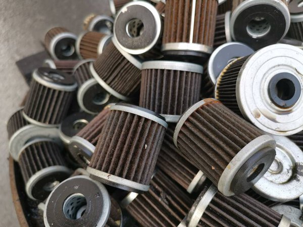 stacks of thrown away car oil filter cyclinderal outdoor,