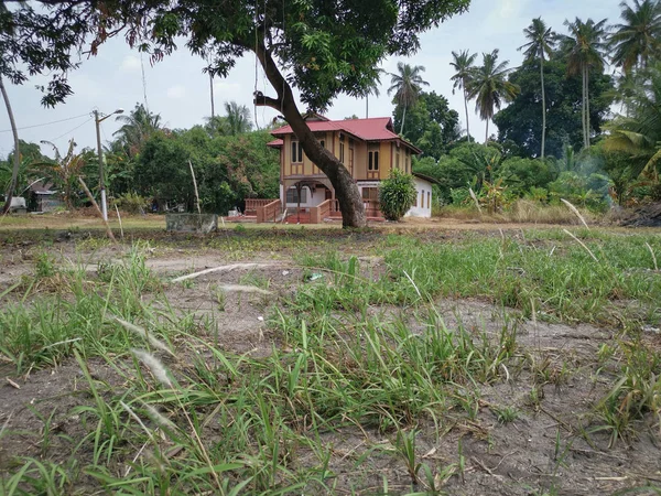 scene of an abandoned malay cottage home.