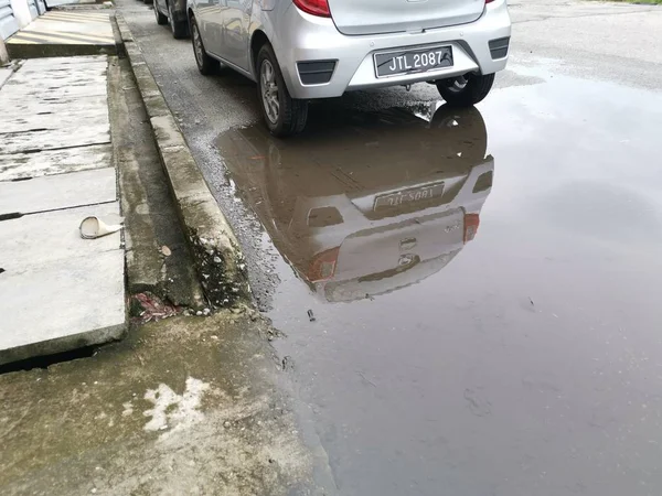 puddle by the street after heavy downfall.