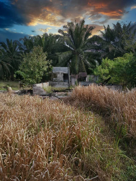 awesome sky scene at abandoned house around the dried grassy field