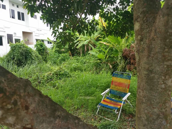 an old foldable lazy chair at the garden.