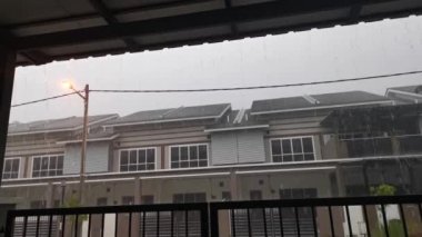 Verandanın dışında şiddetli yağmur yağışının görüntüleri.