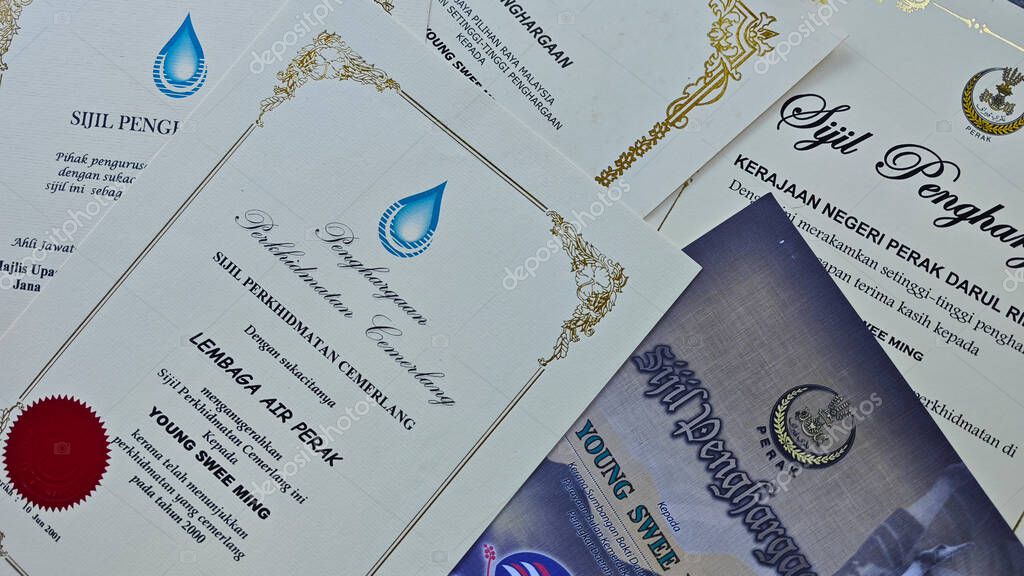 Perak,Malaysia. September 06,2025: Close in display or image of  someone's certificate of appreciation written in official language of Malaysia on display on the floor.