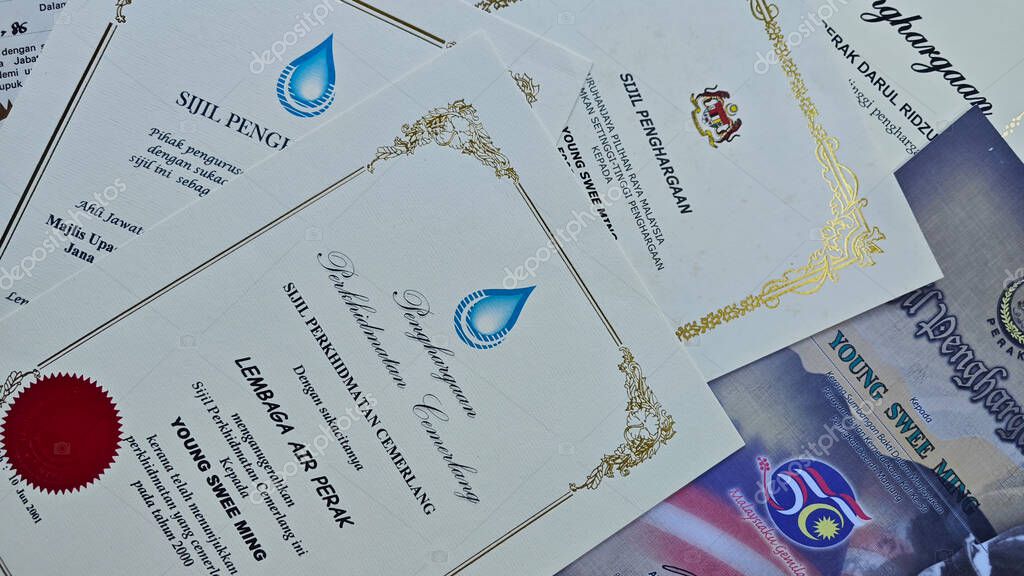 Perak,Malaysia. September 06,2025: Close in display or image of  someone's certificate of appreciation written in official language of Malaysia on display on the floor.