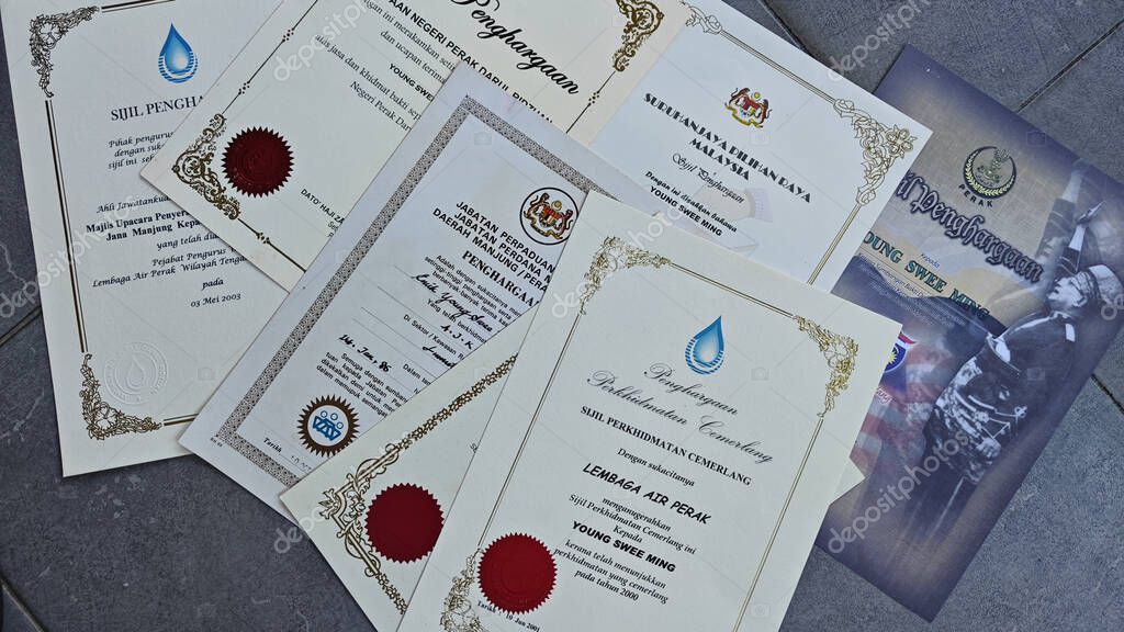 Perak,Malaysia. September 06,2025: Close in display or image of  someone's certificate of appreciation written in official language of Malaysia on display on the floor.