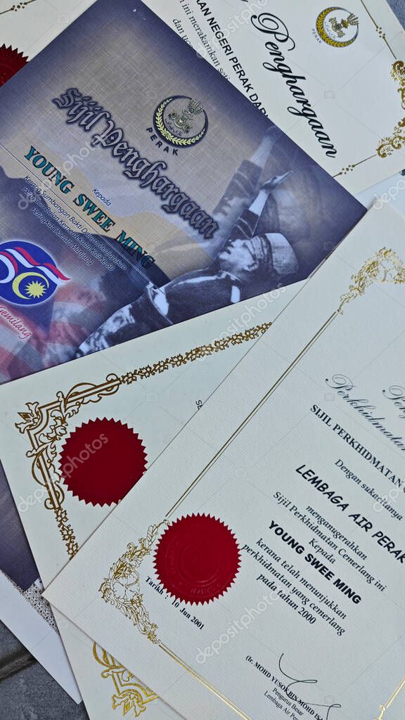 Perak,Malaysia. September 06,2025: Close in display or image of  someone's certificate of appreciation written in official language of Malaysia on display on the floor.