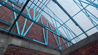 Çatı iskeleti yapımında kullanılan hafif alüminyum çelik kirişe bakıyorum..